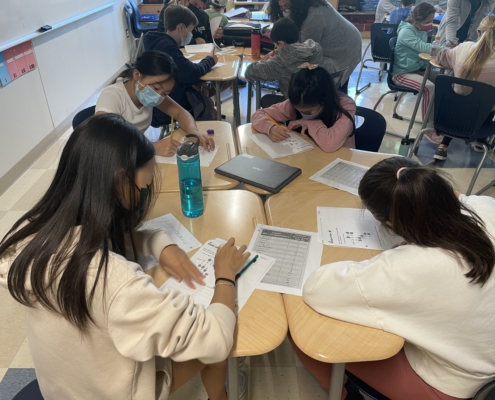 Four students working on a test.
